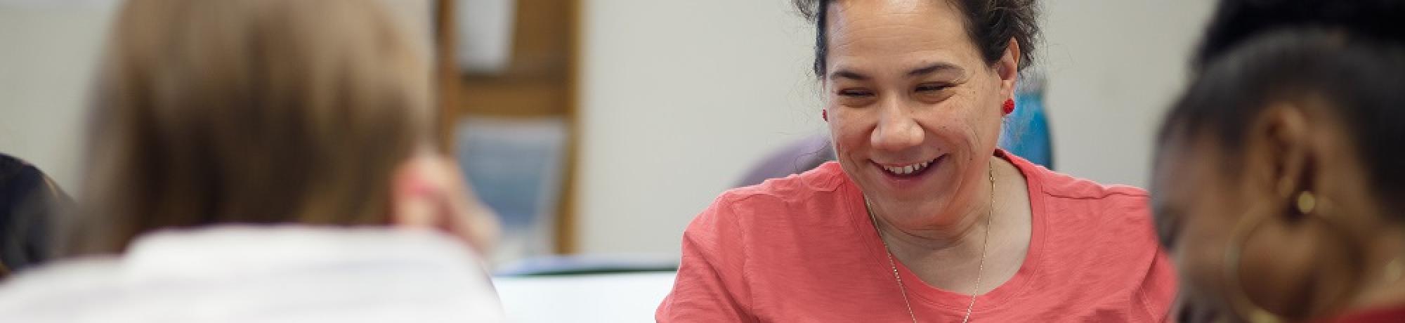 Advisors laugh at table activity.